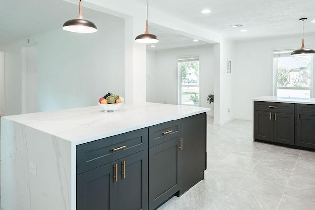 28926 Twisted Oak Dr, Shenandoah, TX 77381 - kitchen featuring light stone countertops, pendant lighting, a kitchen island, and recessed lighting