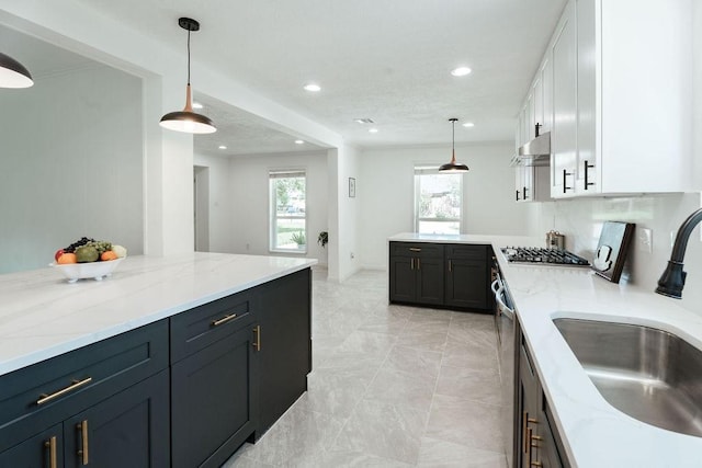 28926 Twisted Oak Dr, Shenandoah, TX 77381 - kitchen with appliances with stainless steel finishes, white cabinets, healthy amount of natural light, light stone countertops, and recessed lighting