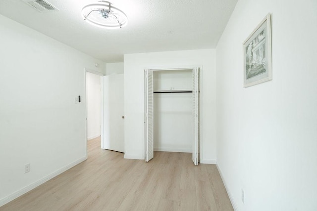 28926 Twisted Oak Dr, Shenandoah, TX 77381 - unfurnished bedroom with light wood-type flooring and a closet
