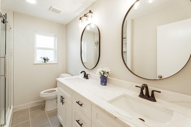 28926 Twisted Oak Dr, Shenandoah, TX 77381 - bathroom with double vanity, tile patterned flooring, and an enclosed shower