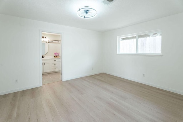 28926 Twisted Oak Dr, Shenandoah, TX 77381 - unfurnished bedroom with light wood-type flooring and ensuite bathroom