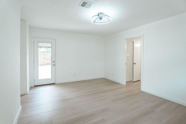28926 Twisted Oak Dr, Shenandoah, TX 77381 - spare room featuring light wood-style flooring and a textured ceiling