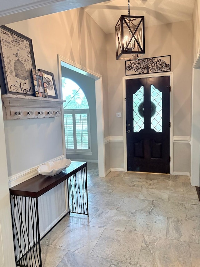 8819 W Rayford Rd, Tomball, TX 77375 - entrance foyer with stone tile flooring and a chandelier