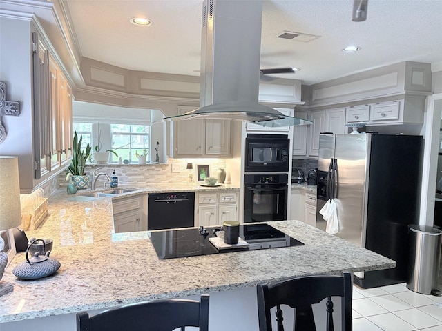 8819 W Rayford Rd, Tomball, TX 77375 - kitchen featuring black appliances, island exhaust hood, a peninsula, light stone counters, and recessed lighting
