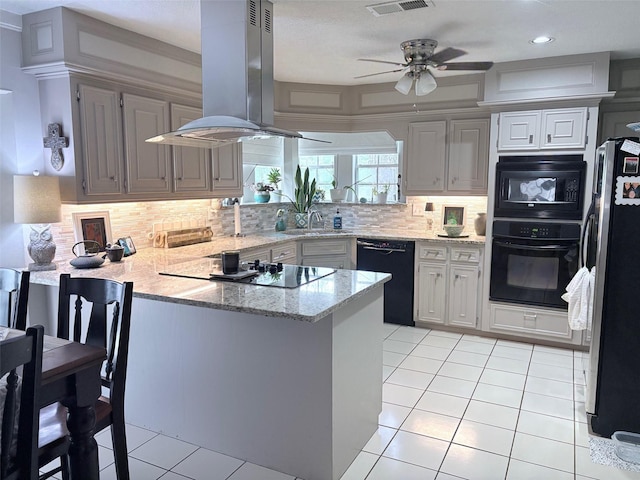 8819 W Rayford Rd, Tomball, TX 77375 - kitchen with black appliances, a peninsula, island exhaust hood, light tile patterned floors, and ceiling fan