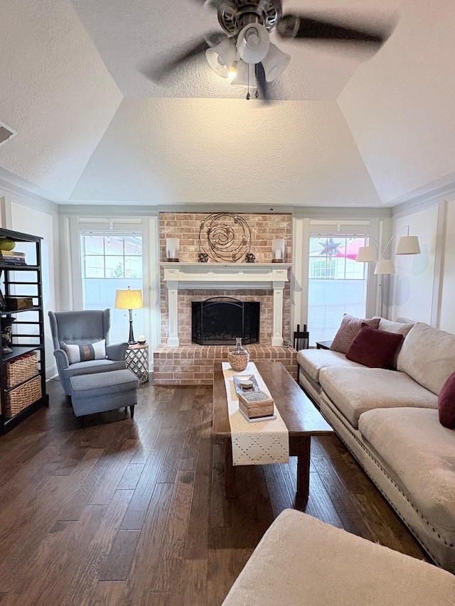 8819 W Rayford Rd, Tomball, TX 77375 - living room featuring vaulted ceiling, dark wood-type flooring, plenty of natural light, a ceiling fan, and a textured ceiling
