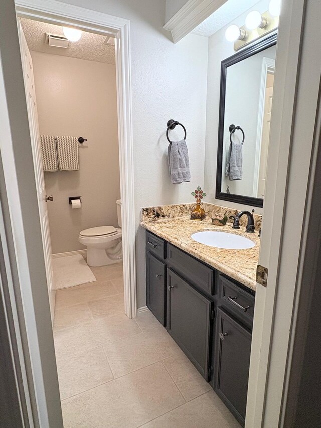 8819 W Rayford Rd, Tomball, TX 77375 - bathroom featuring vanity, tile patterned floors, and a textured ceiling