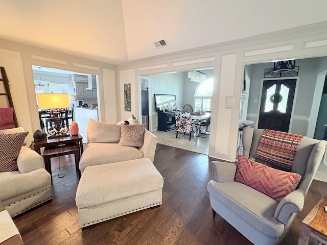 8819 W Rayford Rd, Tomball, TX 77375 - living room featuring dark wood-style flooring, a chandelier, and lofted ceiling