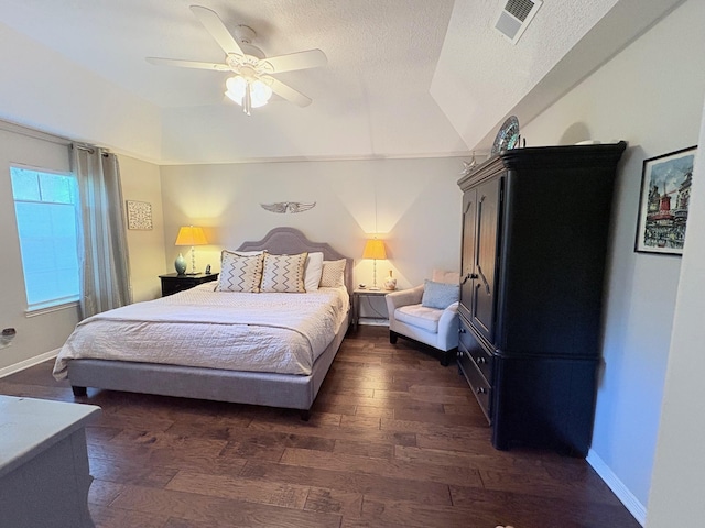 8819 W Rayford Rd, Tomball, TX 77375 - bedroom with dark wood-style flooring, vaulted ceiling, ceiling fan, and a textured ceiling