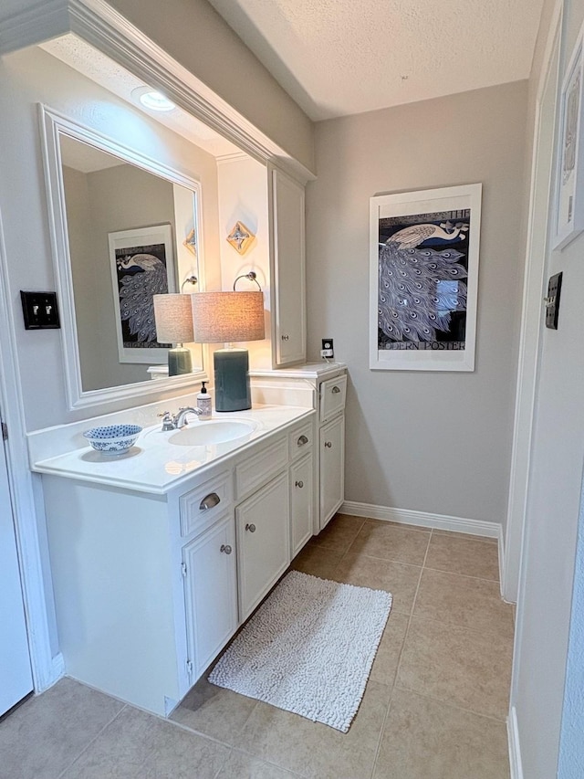 8819 W Rayford Rd, Tomball, TX 77375 - bathroom featuring vanity, tile patterned floors, and a textured ceiling