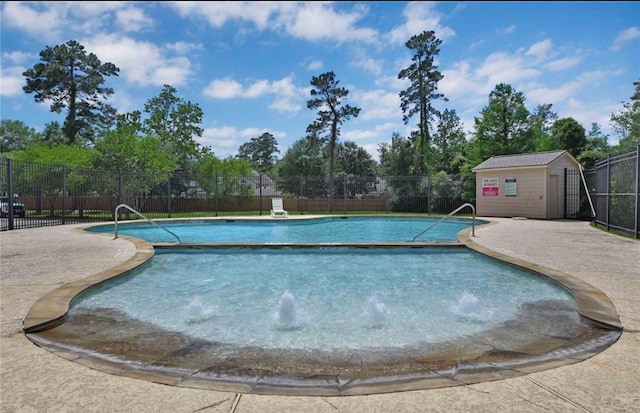 8819 W Rayford Rd, Tomball, TX 77375 - community pool featuring a patio, an outbuilding, and view of scattered trees