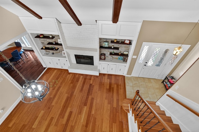 5903 Havenwoods Dr, Houston, TX 77066 - living room featuring a fireplace, light wood-style floors, beamed ceiling, and stairway