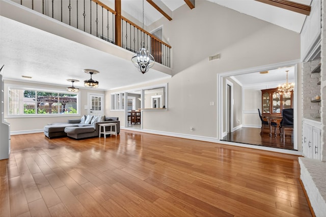 5903 Havenwoods Dr, Houston, TX 77066 - living room featuring a chandelier, wood finished floors, beamed ceiling, and high vaulted ceiling