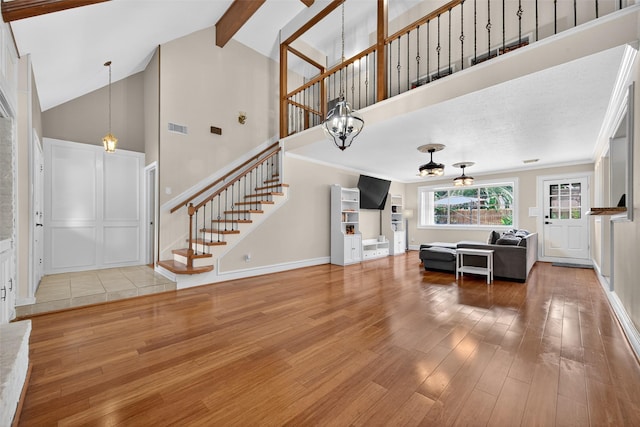 5903 Havenwoods Dr, Houston, TX 77066 - living area featuring wood finished floors, stairway, high vaulted ceiling, a chandelier, and beam ceiling