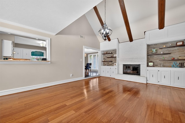 5903 Havenwoods Dr, Houston, TX 77066 - unfurnished living room featuring a chandelier, wood finished floors, a brick fireplace, high vaulted ceiling, and beamed ceiling