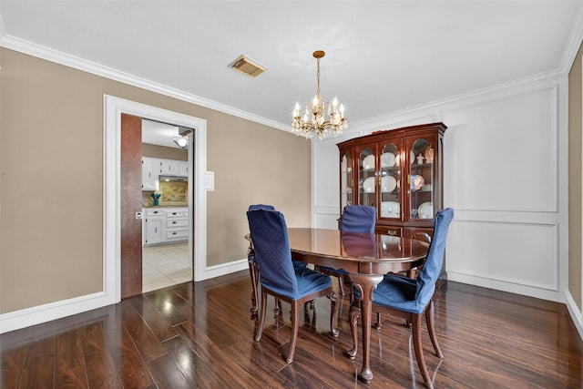 5903 Havenwoods Dr, Houston, TX 77066 - dining area with a chandelier, crown molding, and dark wood-style floors
