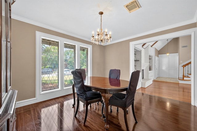 5903 Havenwoods Dr, Houston, TX 77066 - dining room featuring a chandelier, wood finished floors, stairway, ornamental molding, and vaulted ceiling