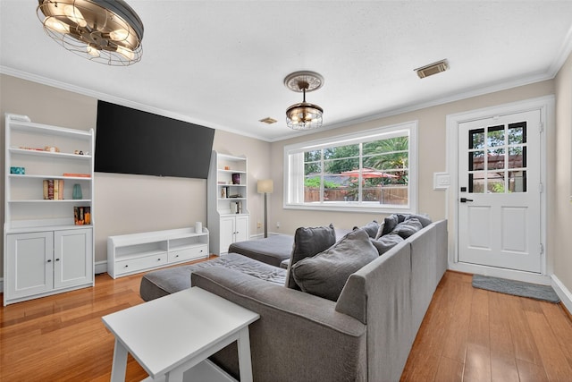 5903 Havenwoods Dr, Houston, TX 77066 - living area featuring light wood-style floors, a chandelier, and crown molding