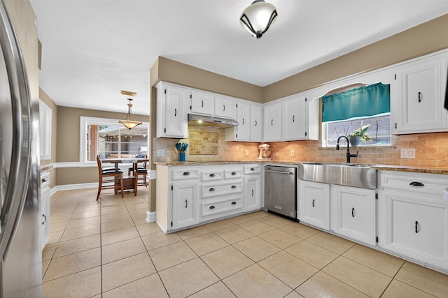 5903 Havenwoods Dr, Houston, TX 77066 - kitchen with stainless steel appliances, decorative backsplash, white cabinetry, and light tile patterned floors