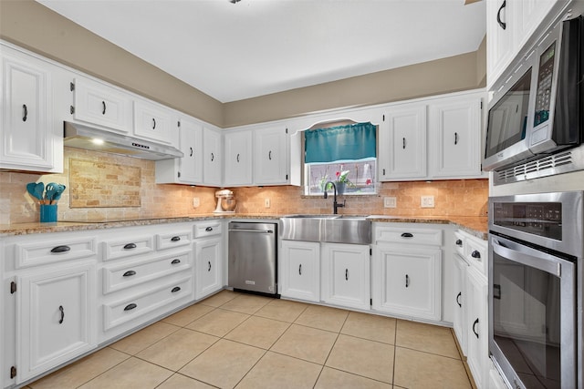 5903 Havenwoods Dr, Houston, TX 77066 - kitchen featuring stainless steel appliances, light tile patterned flooring, and white cabinetry