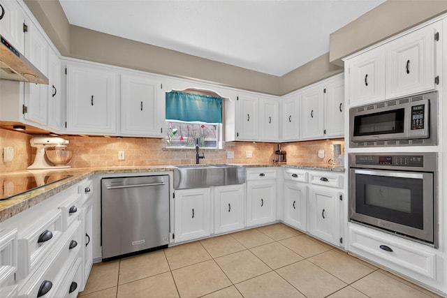 5903 Havenwoods Dr, Houston, TX 77066 - kitchen featuring stainless steel appliances, light tile patterned flooring, and white cabinets
