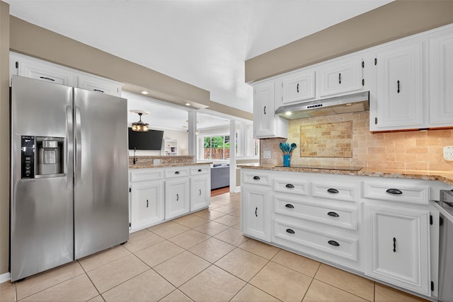 5903 Havenwoods Dr, Houston, TX 77066 - kitchen featuring stainless steel refrigerator with ice dispenser, under cabinet range hood, black electric cooktop, decorative backsplash, and white cabinetry