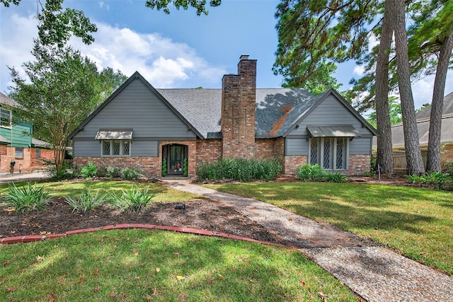 5903 Havenwoods Dr, Houston, TX 77066 - view of front of house featuring brick siding, a chimney, and a shingled roof