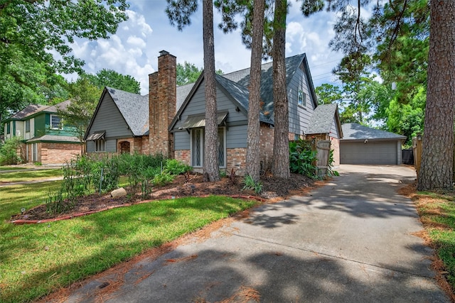 5903 Havenwoods Dr, Houston, TX 77066 - view of front facade with brick siding, a chimney, a detached garage, and a shingled roof