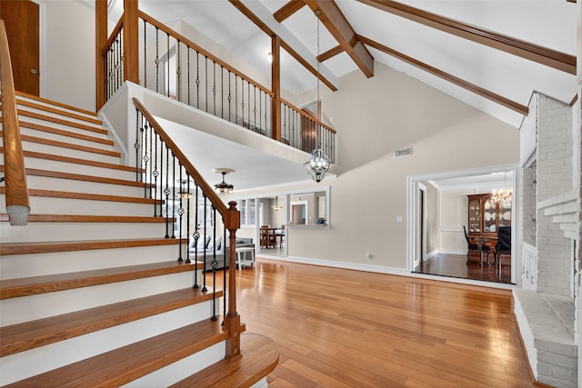 5903 Havenwoods Dr, Houston, TX 77066 - staircase with a chandelier, high vaulted ceiling, beamed ceiling, and hardwood / wood-style flooring