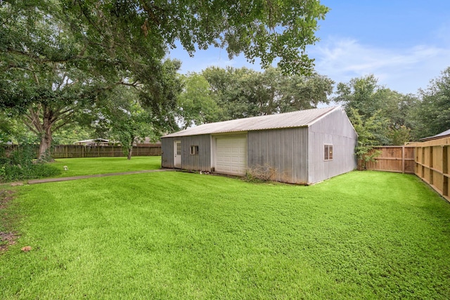 2121 Redwood St, Kemah, TX 77565 - fenced backyard with an outdoor structure and a detached garage