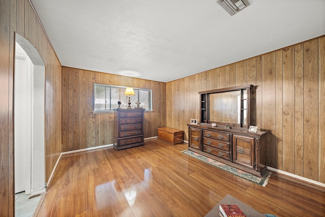 2121 Redwood St, Kemah, TX 77565 - bedroom with arched walkways, wood finished floors, and wood walls