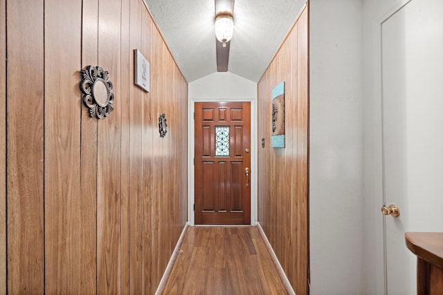 2121 Redwood St, Kemah, TX 77565 - doorway featuring wood finished floors, wood walls, and a textured ceiling