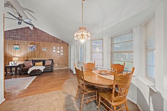 2121 Redwood St, Kemah, TX 77565 - dining area featuring wood walls, lofted ceiling, ceiling fan, a chandelier, and wood finished floors