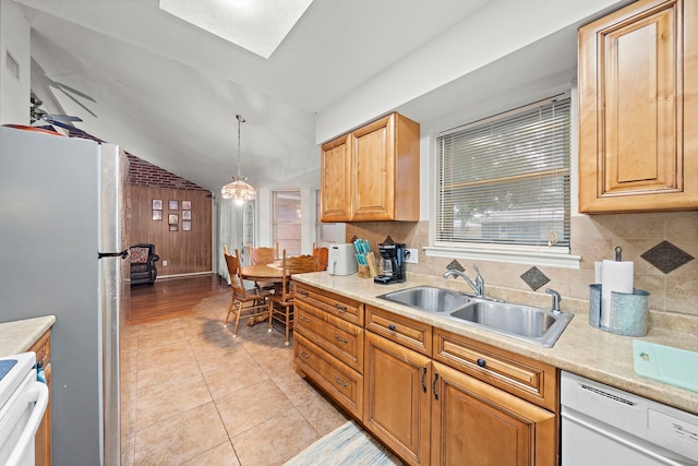 2121 Redwood St, Kemah, TX 77565 - kitchen with stove, dishwasher, light countertops, hanging light fixtures, and light tile patterned floors