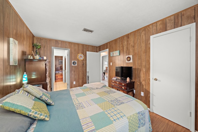 2121 Redwood St, Kemah, TX 77565 - bedroom featuring wood walls and light wood finished floors