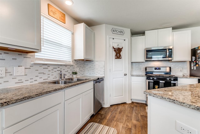 1007 Cozumel Emerald, San Antonio, TX 78253 - kitchen with appliances with stainless steel finishes, white cabinetry, wood finished floors, and backsplash