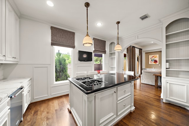 1229 Ripple Creek Dr, Houston, TX 77057 - kitchen with stainless steel dishwasher, arched walkways, black gas stovetop, built in shelves, and ornamental molding