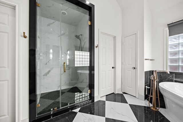 1229 Ripple Creek Dr, Houston, TX 77057 - full bathroom with marble tiled floors, a marble finish shower, and a soaking tub
