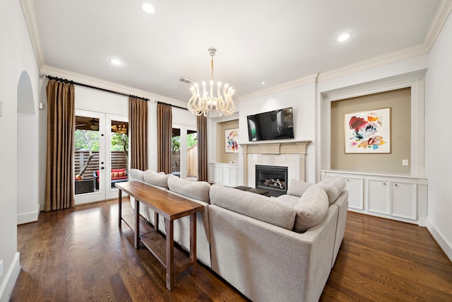 1229 Ripple Creek Dr, Houston, TX 77057 - living area with ornamental molding, a glass covered fireplace, dark wood-type flooring, a chandelier, and recessed lighting