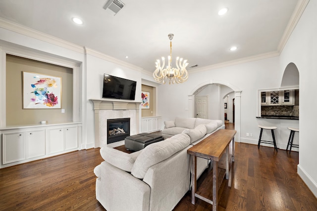 1229 Ripple Creek Dr, Houston, TX 77057 - living area featuring arched walkways, crown molding, a high end fireplace, dark wood finished floors, and a chandelier