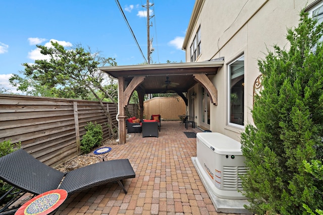 1229 Ripple Creek Dr, Houston, TX 77057 - fenced backyard with a patio, ceiling fan, and an outdoor hangout area