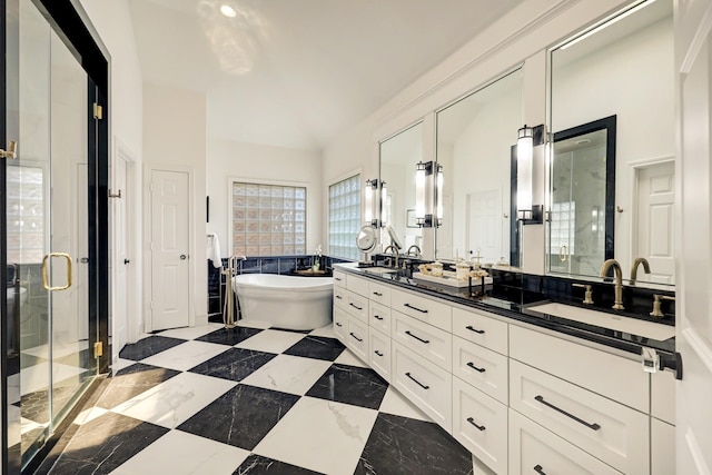 1229 Ripple Creek Dr, Houston, TX 77057 - bathroom featuring double vanity, a stall shower, a freestanding bath, marble tiled flooring, and vaulted ceiling