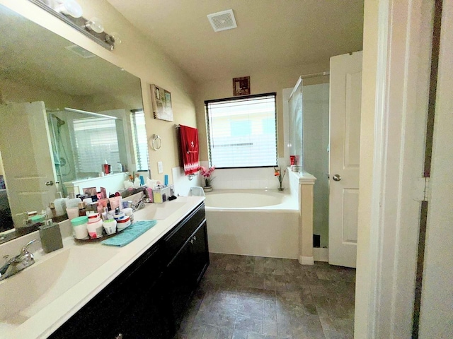 2315 Shady Tree Ln, Conroe, TX 77301 - bathroom featuring a stall shower, a bath, double vanity, and stone finish floors