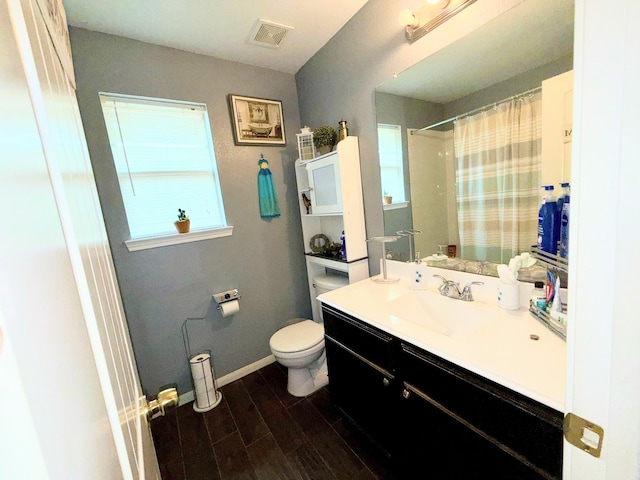 2315 Shady Tree Ln, Conroe, TX 77301 - full bathroom with vanity, wood finished floors, healthy amount of natural light, and curtained shower