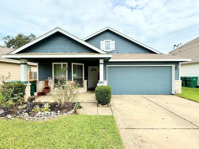2315 Shady Tree Ln, Conroe, TX 77301 - craftsman house featuring a porch, driveway, an attached garage, and a front lawn