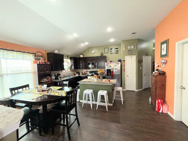 2315 Shady Tree Ln, Conroe, TX 77301 - dining area with lofted ceiling and dark wood-style floors