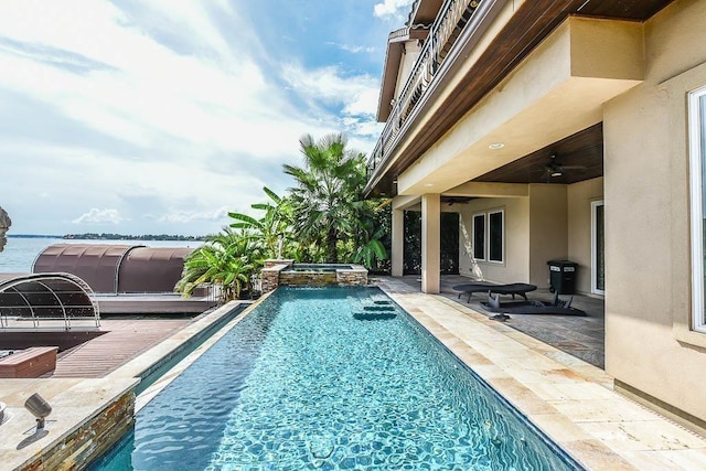 12349 Tramonto Dr, Conroe, TX 77304 - view of swimming pool with a pool with connected hot tub, ceiling fan, and a patio