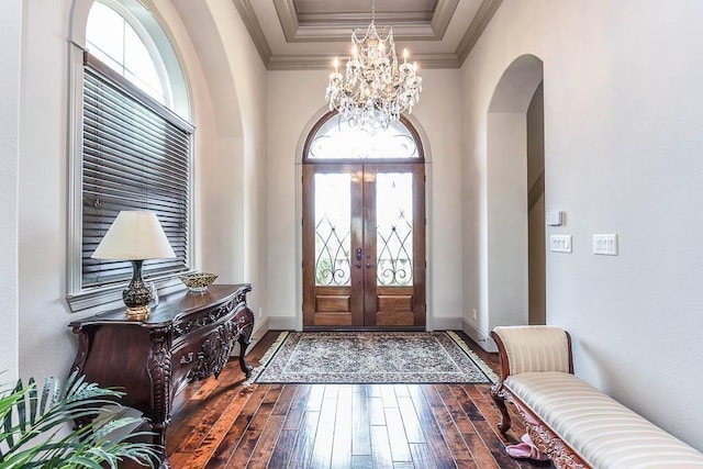 12349 Tramonto Dr, Conroe, TX 77304 - foyer featuring healthy amount of natural light, arched walkways, a chandelier, french doors, and crown molding