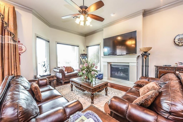 12349 Tramonto Dr, Conroe, TX 77304 - living area with wood finished floors, a ceiling fan, crown molding, and a glass covered fireplace