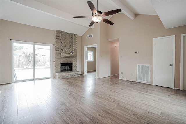 1103 W Brompton Dr, Pearland, TX 77584 - unfurnished living room featuring ceiling fan, beamed ceiling, high vaulted ceiling, wood finished floors, and a fireplace